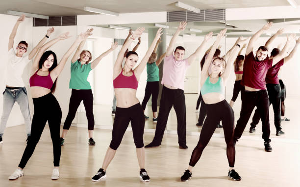 istock Smiling men and ladies dancing aerobics at lesson 1067040394