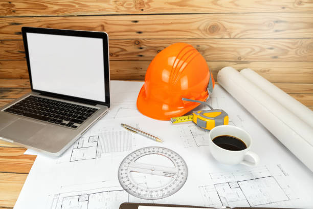 istock Cup of coffee with helmet and etc. on blueprint, architectural concept 1067040836