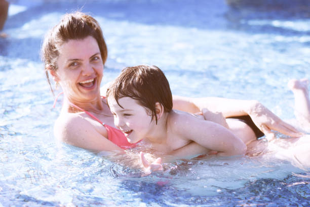 istock Mom and son in swimming pool 1067041118