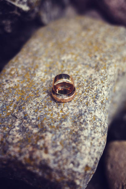 istock Two wedding rings place on stone 1067044062