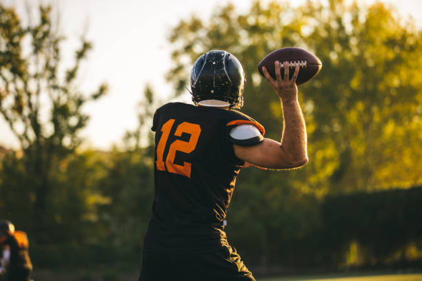 istock American Football Player throwing the ball 1067048302