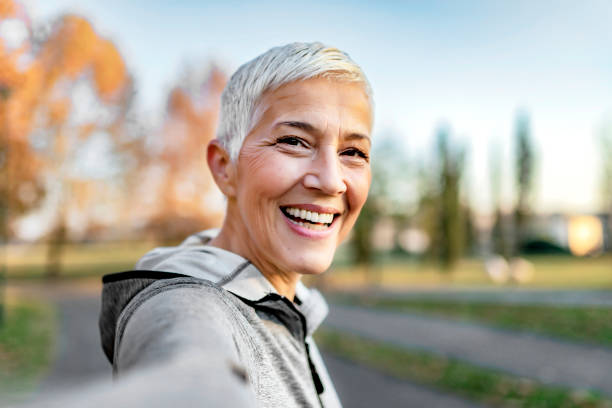 Who said selfies are just for the youth? Close Up Portrait of Happy Cheerful Delightful Charming Beautiful Mature Lady Granny Grandma Taking a Selfie on Vacation. Selfie Portrait of Happy Senior Woman With Short Gray Hair Outdoor. Sporty Senior Woman Taking Selfie in the Park After Workout. eastern european 50s mature women beauty stock pictures, royalty-free photos & images