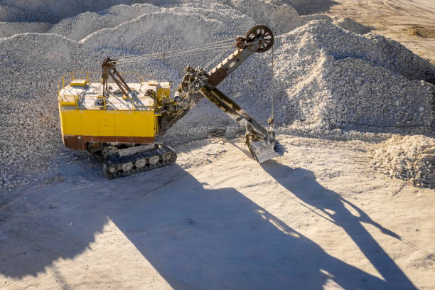 istock Excavator loads ore in the quarry, aerial view 1067054146