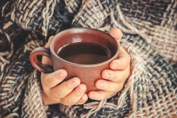 istock A cup of tea and a cozy autumn background. Selective focus. 1067054778