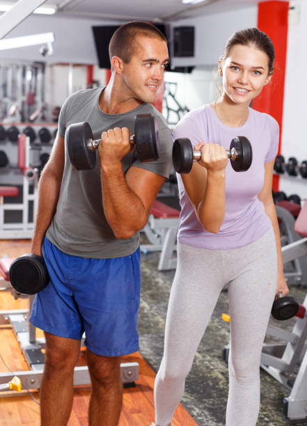 istock Couple doing exercises with dumbbells 1067057228