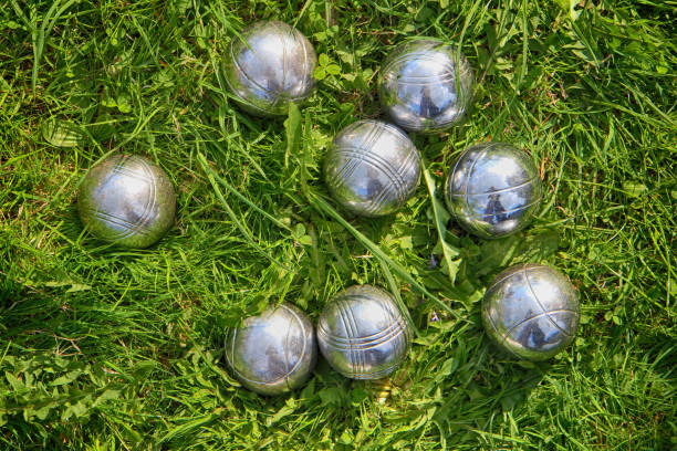 petanque bowls in the green grass as sport background