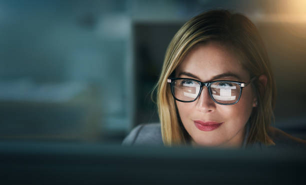 Seeing the true benefits of her hard work Shot of a young businesswoman working late on a computer in an office working late photos stock pictures, royalty-free photos & images