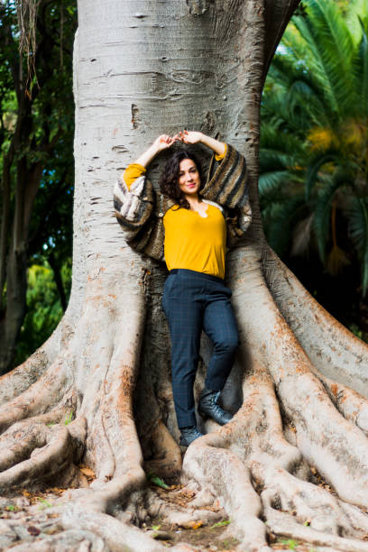 istock woman with brunette hair in the park 1067060708