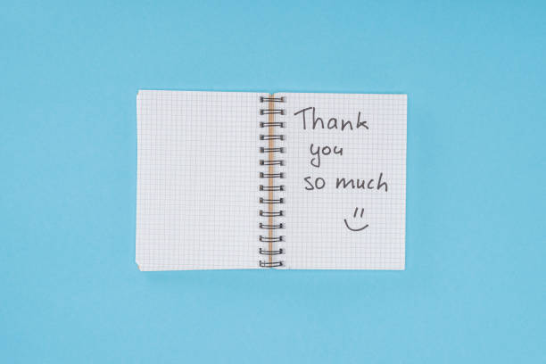 istock notebook with thank you so much lettering isolated on blue background 1067061218