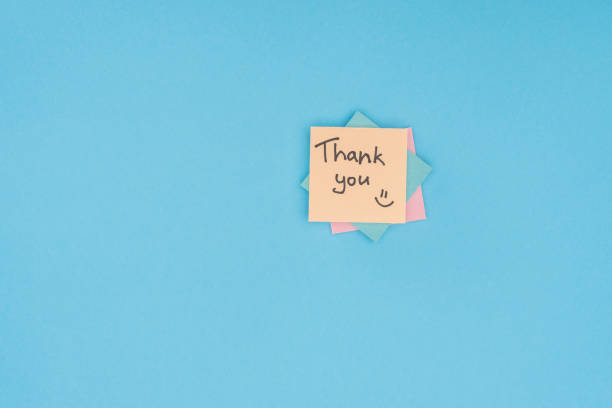 istock colorful sticky notes with thank you lettering isolated on blue background 1067061236