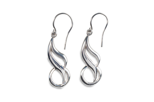 Studio image of a pair of silver earrings isolated on a white background.