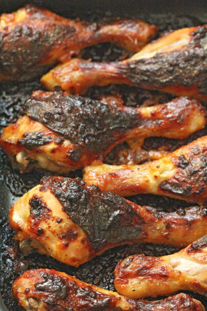 istock Grilled chicken legs with spices and garlic. Crispy fried chicken. Top view 1067066826