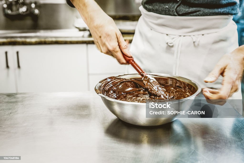 Only chocolate, always Preparation of chocolate and making truffles. Baker - Occupation Stock Photo