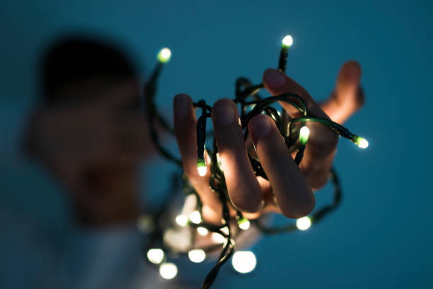 istock hand with the christmas lights 1067068292