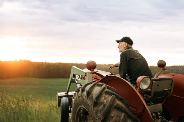 what’s a farmer without his tractor? - farmer imagens e fotografias de stock