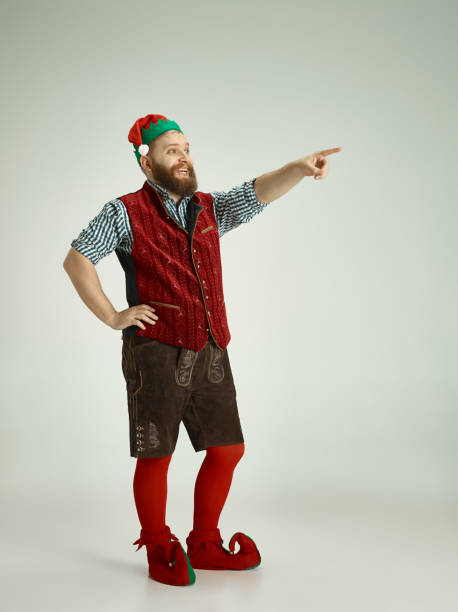 istock friendly man dressed like a funny gnome posing on an isolated gray background 1067071780