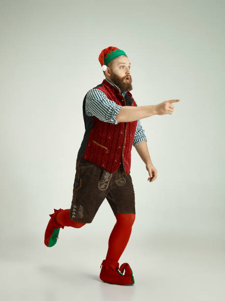istock friendly man dressed like a funny gnome posing on an isolated gray background 1067071808