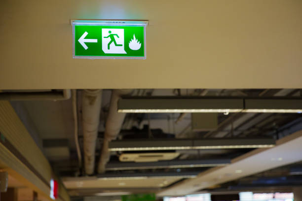 istock Green emergency exit sign showing the way to escape. Fire exit in the building. 1067072098