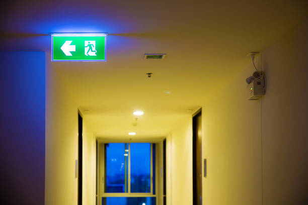 istock Green emergency exit sign showing the way to escape. Fire exit in the building. 1067072434