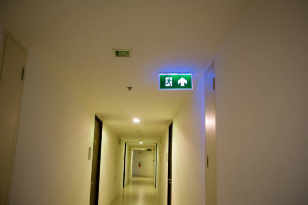 istock Green emergency exit sign showing the way to escape. Fire exit in the building. 1067072578