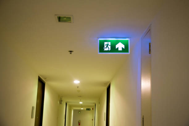 istock Green emergency exit sign showing the way to escape. Fire exit in the building. 1067074122