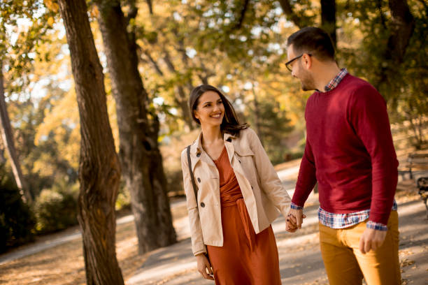 istock Young couple walking in the autumn park 1067074342