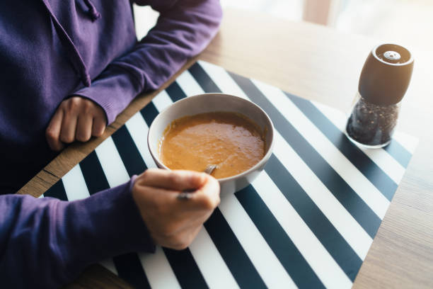 young woman eating tarhana soup at home - food vegan food gourmet vegetarian food imagens e fotografias de stock