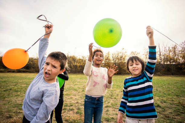 istock Cheerful kids playing with balloon's 1067075614