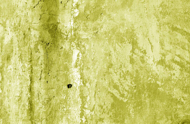 istock Grungy cement wall texture in yellow tone. 1067079302