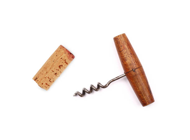 Vintage wine bottle opener and cork isolated One old vintage wooden corkscrew bottle opener and red wine cork isolated on white background, elevated top view, directly above cork material stock pictures, royalty-free photos & images