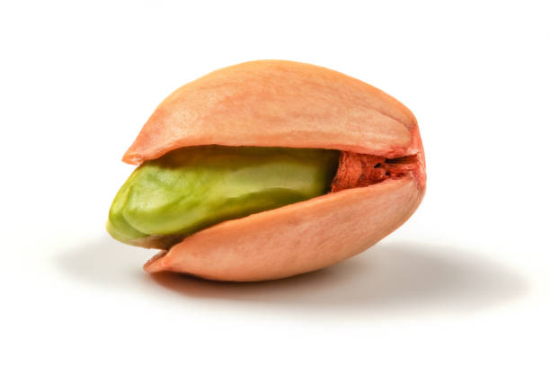 istock Single pistachio shell, with peeled green shell inside, isolated on white background. 1067081672