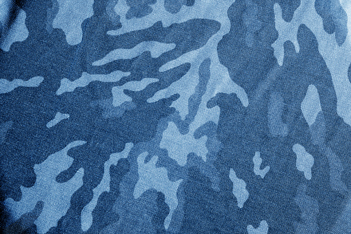 Antiguo paño de camuflaje con blur efecto en tono azul marino. photo