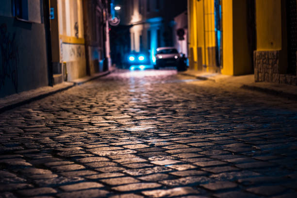 istock City at night with cobblestone road 1067086744
