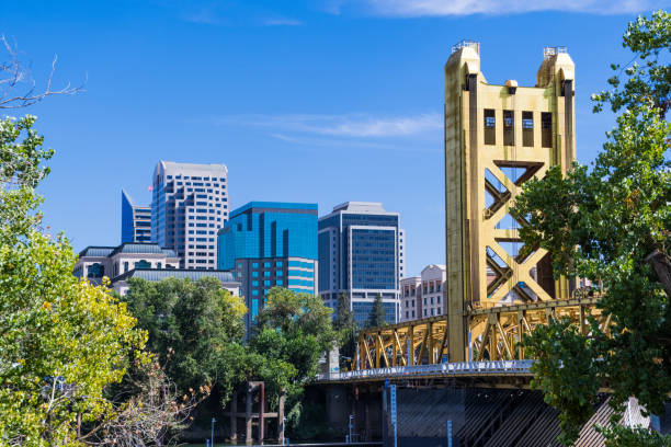 Aerial shot of Sacramento, California on a cloudy day in early spring. The river is flowing past the city and beneath Tower Bridge, with the California State Capitol in the distance.\n\nAuthorization was obtained from the FAA for this operation in restricted airspace.