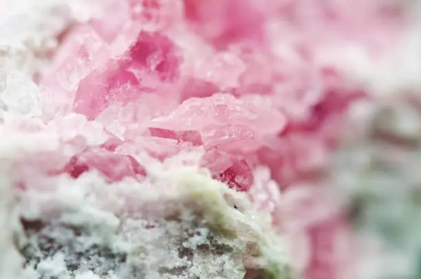 Pink crystals Rhodochrosite with particles of Pyrite. Natural  texture of mineral for background. Beautiful background and wallpaper. Macro