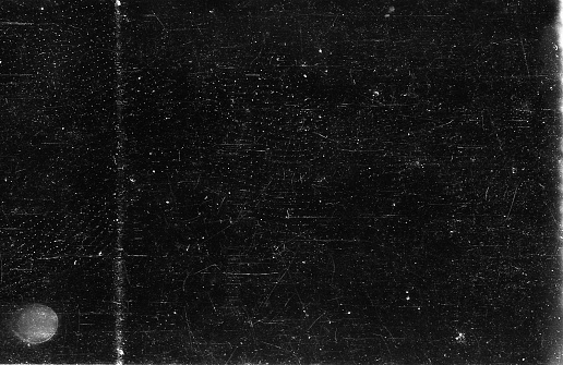 A close-up scan of an old scratched 35mm film strip grunge texture background.