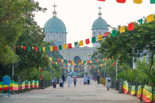 Medhane Alem Cathedral in Addis Ababa Ethiopia People walk near the Medhane Alem Cathedral during the Timkat Festival, an annual Orthodox Christian celebration of the Epiphany, in Addis Ababa, Ethiopia. addis ababa ethiopia photos stock pictures, royalty-free photos & images