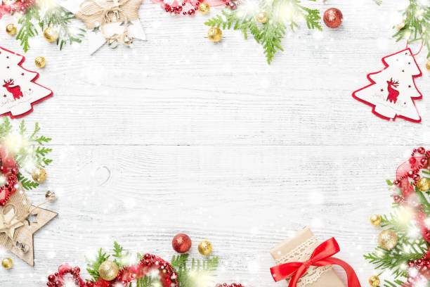 Bright shining frame of red & gold Christmas decorations on light copy space.