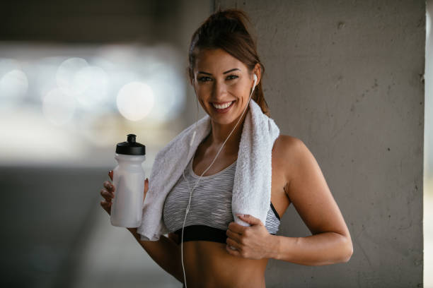 istock Smiling woman resting after workout 1067090342
