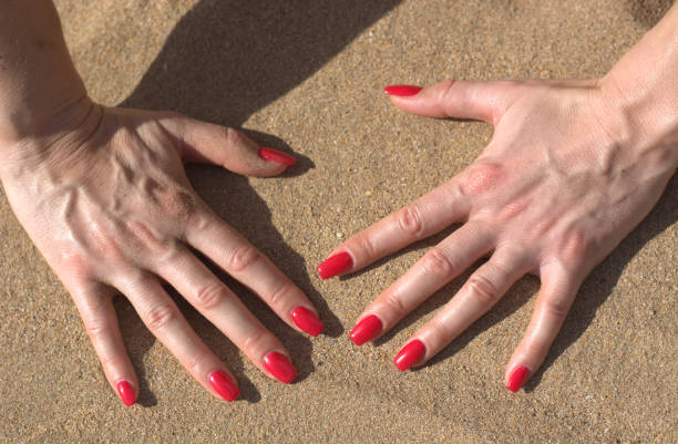 istock beautiful hands on the sand 1067092858