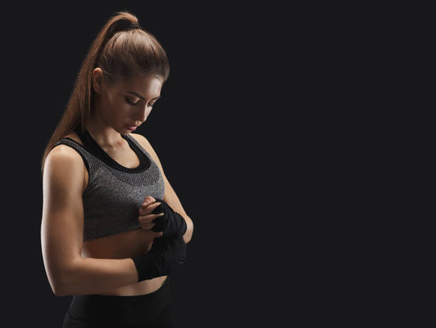 istock Athletic boxer wrapping hands with boxing bandage 1067093664