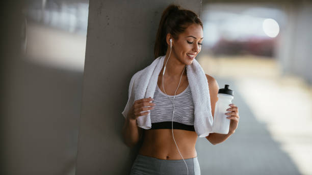 istock Smiling woman resting after workout 1067095254