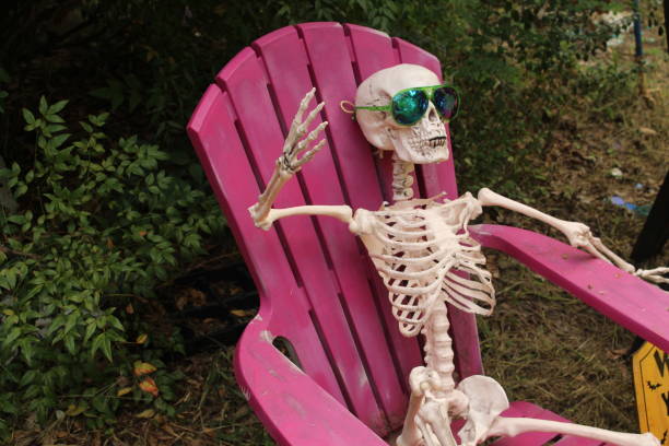istock Skeleton waving in a chair 1067096450