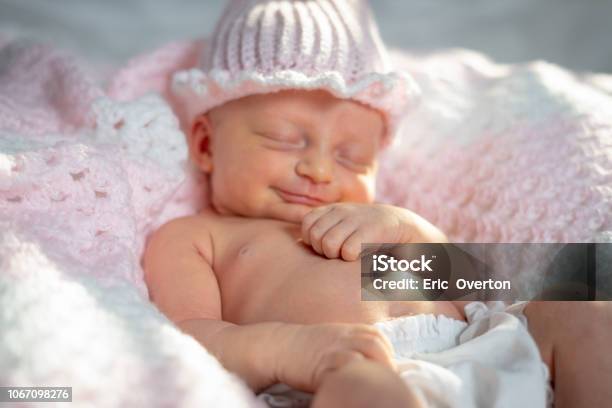 Newborn Baby Girl In A Pink Hat On A Pink Blanket Stock Photo - Download Image Now - Babies Only, Baby - Human Age, Baby Girls