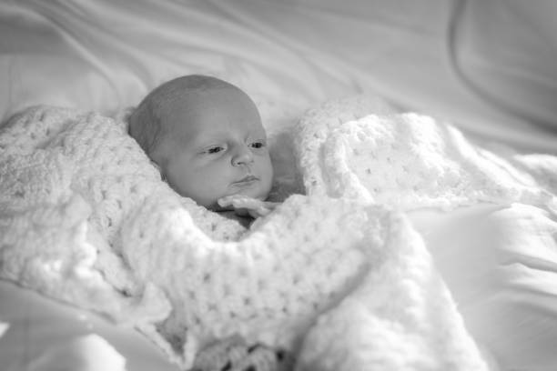 Black and white photo of a newborn baby girl stock photo