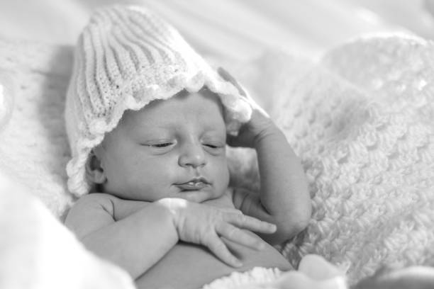 Black and white photo of a newborn baby girl stock photo