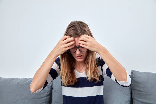 istock Young woman with headache / pain holding head. 1067105002