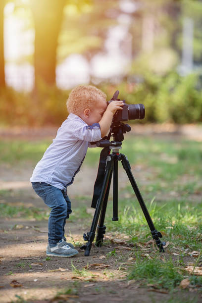 istock A two years old boy is photographer. 1067115650