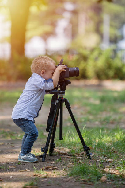 istock A two years old boy is photographer. 1067115900