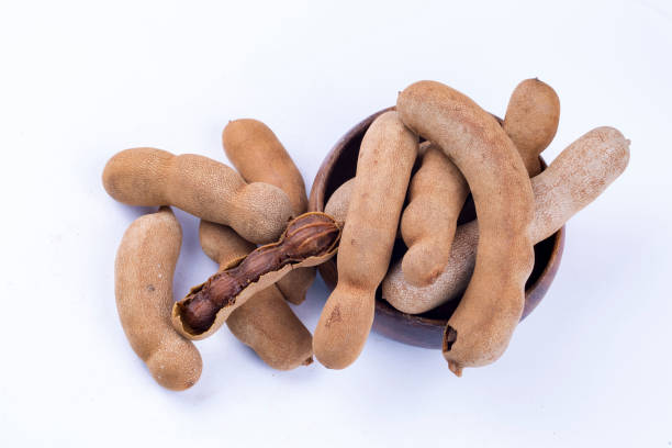 istock Dried tamarind fruits isolated on a white background 1067117550